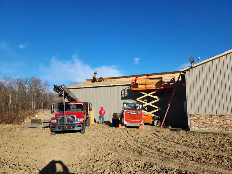 Rick's Roofing crew installing windows and doors on a commercial building in Indiana